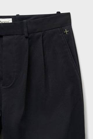 Organic Cotton Stretch Black Pleated Trouser with Button Fastening. Sustaianably made with Sondrio Italian material which uses 90% of its energy on-site, with 83% of its waste being recovered for reuse.  