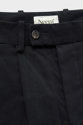 Organic Cotton Stretch Black Pleated Trouser with Button Fastening. Sustaianably made with Sondrio Italian material which uses 90% of its energy on-site, with 83% of its waste being recovered for reuse.  