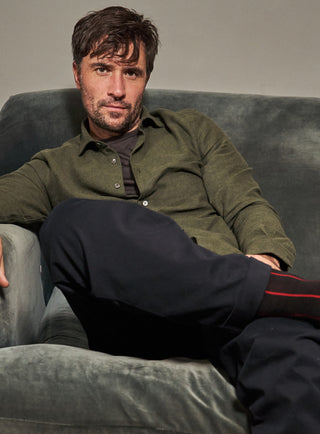 A long-sleeved green flannel shirt with a collar, button-up front, and a regular fit.