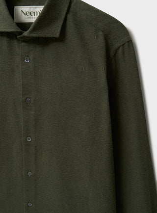A long-sleeved green flannel shirt with a collar, button-up front, and a regular fit.
